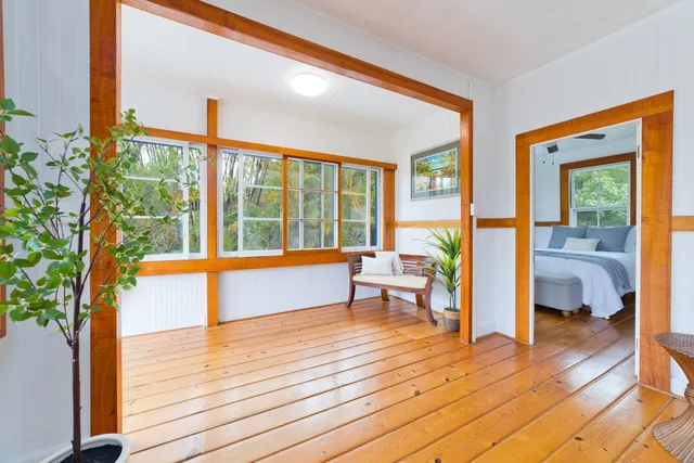 a living room filled with furniture and a large window