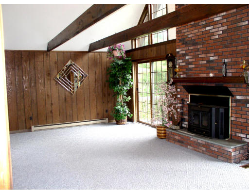 88 Beaver Road Ware, MA 01082 - Photo 3 of 4 a view of an empty room with a fireplace and a window