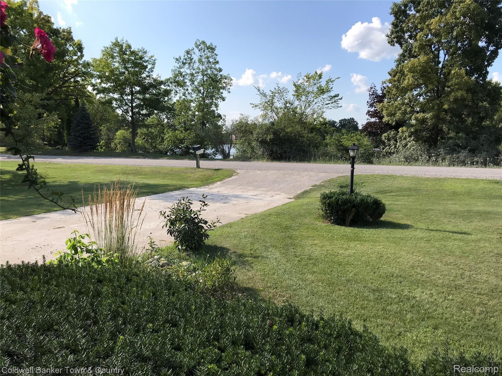 2442 Fisher Road Howell, MI 48855 - Photo 17 of 25 Sunsets and lake views from covered porch