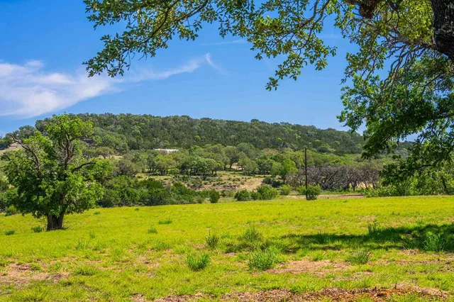 a view of a kitchen counter space wooden floor and stainless steel appliances