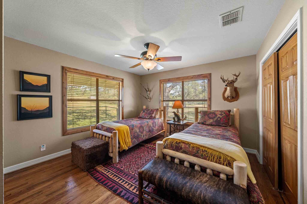161 Flach Rnch Road Comfort, TX 78013 - Photo 41 of 69 a bedroom with two beds and a window