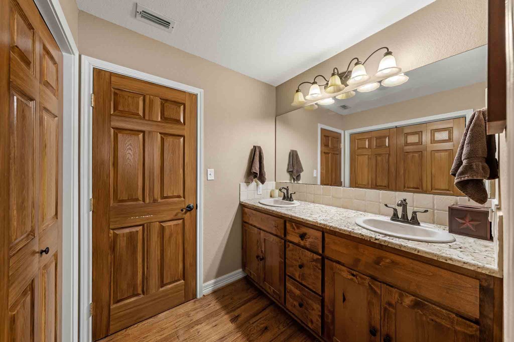 161 Flach Rnch Road Comfort, TX 78013 - Photo 42 of 69 a bathroom with a double vanity sink and a mirror