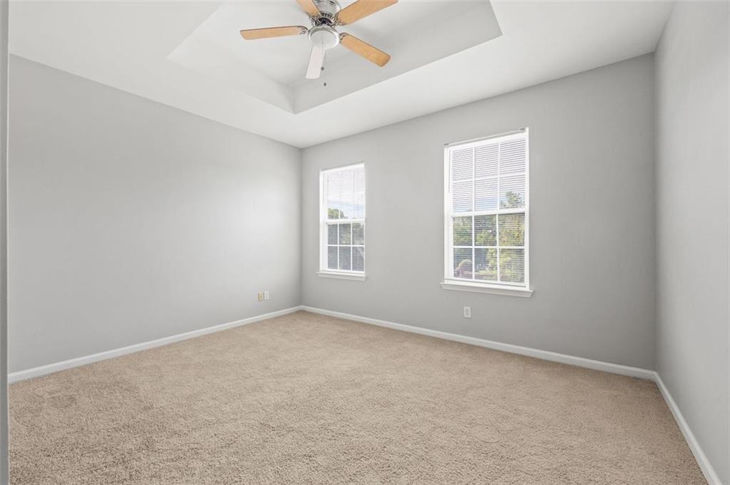 1752 Pryor Road Southwest, Unit 111 Atlanta, GA 30315 - Photo 12 of 21 an empty room with windows and fan
