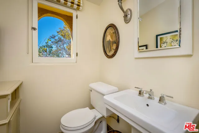 a view of a livingroom with furniture and bookshelf