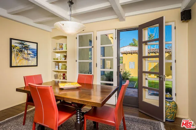 a living room with a couch and a flat screen tv with wooden floor
