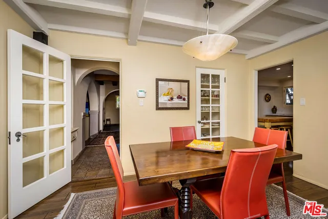 a bathroom with a granite countertop sink a mirror and a refrigerator