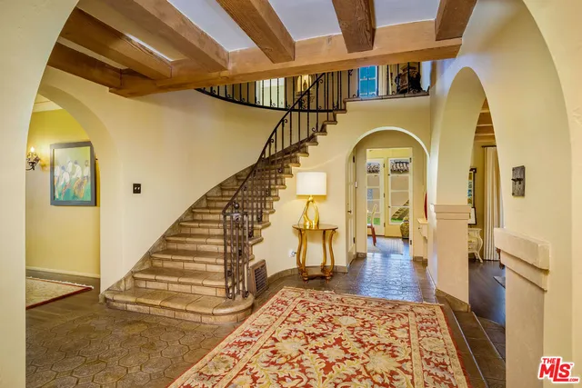 a dining room with furniture a rug and wooden floor