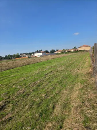 a view of a field with an outdoor space and seating