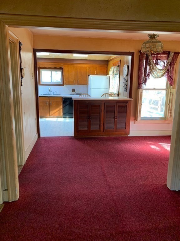 29 May Street Spencer, MA 01562 - Photo 11 of 27 a view of empty room with window and fireplace