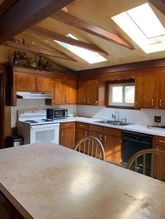 29 May Street Spencer, MA 01562 - Photo 12 of 27 a kitchen with stainless steel appliances granite countertop a sink a stove and a wooden cabinets