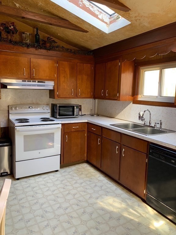29 May Street Spencer, MA 01562 - Photo 13 of 27 a kitchen with a stove sink and cabinets
