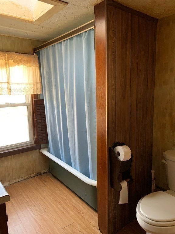 29 May Street Spencer, MA 01562 - Photo 18 of 27 a bathroom with a toilet a sink and a mirror