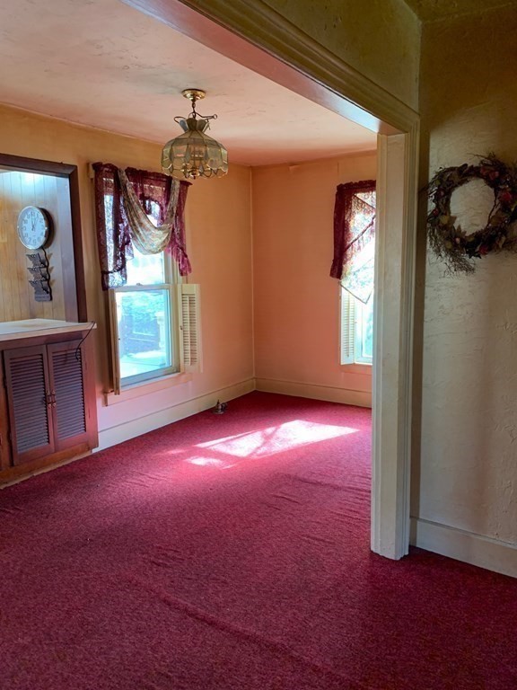 29 May Street Spencer, MA 01562 - Photo 6 of 27 an empty room with windows and cabinet
