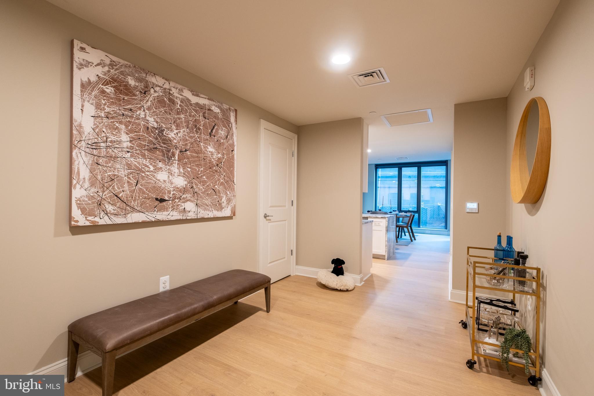 2301-61 John F Kennedy Boulevard, Unit 210 Philadelphia, PA 19103 - Photo 16 of 36 a bedroom with furniture and a chandelier