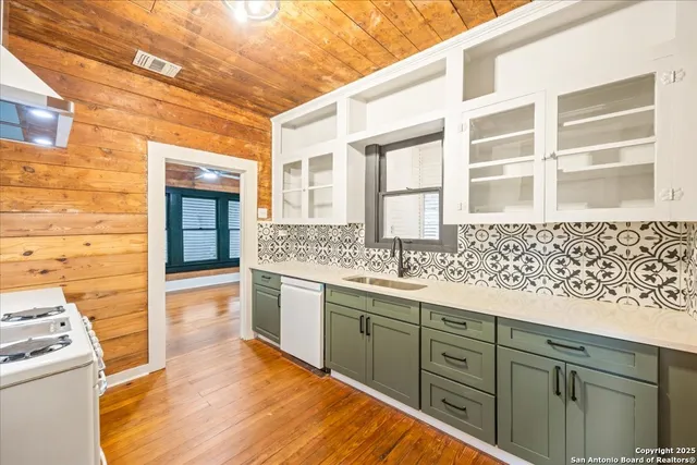 a spacious bathroom with a granite countertop sink and a mirror