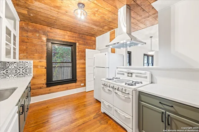 a kitchen with stainless steel appliances granite countertop a stove and a refrigerator