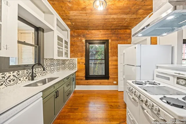 a kitchen with a sink stove and refrigerator