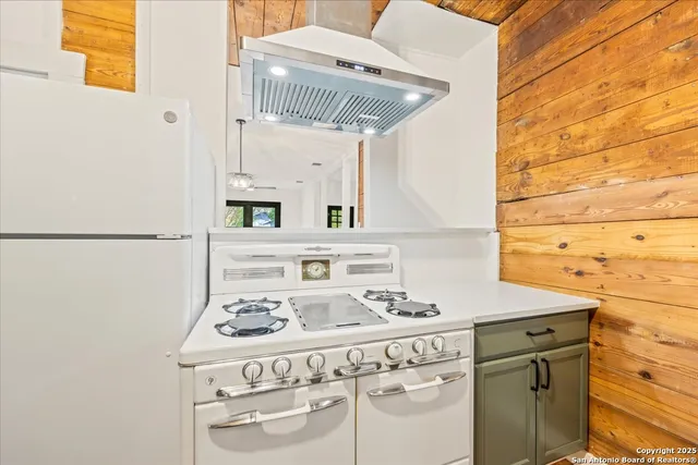 a kitchen with a sink a stove and a refrigerator