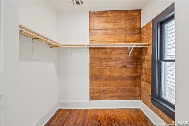 a view of a room with wooden floor and windows