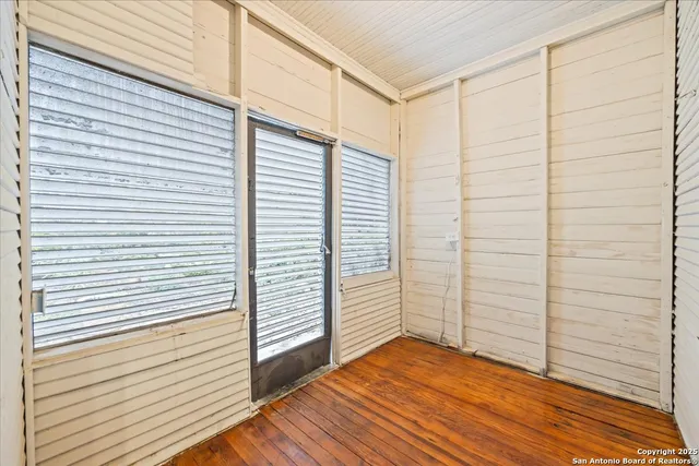 a view of a room with wooden floor