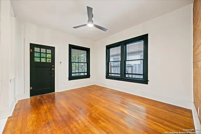 a bedroom with a bed and a large window