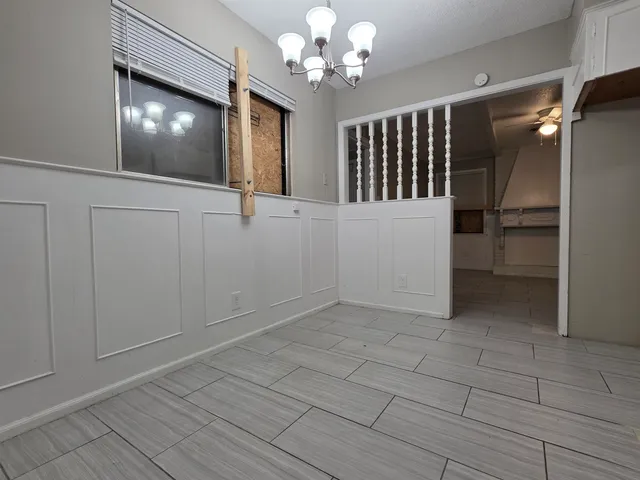 a view of a hallway with chandelier