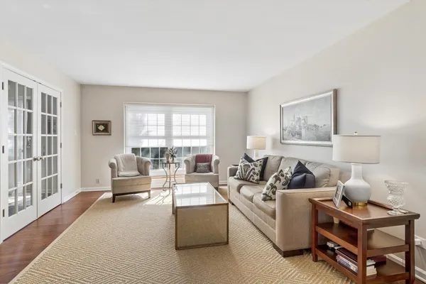 a dining room with furniture window and wooden floor
