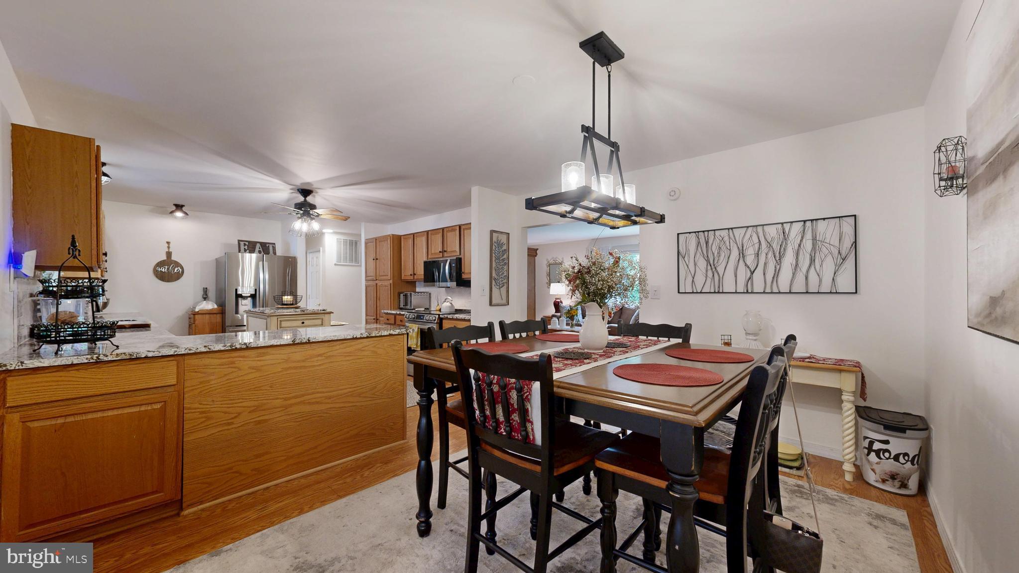 705 Deer Track Lane Dover, DE 19904 - Photo 11 of 29 a view of a dining room and livingroom with furniture wooden floor a chandelier