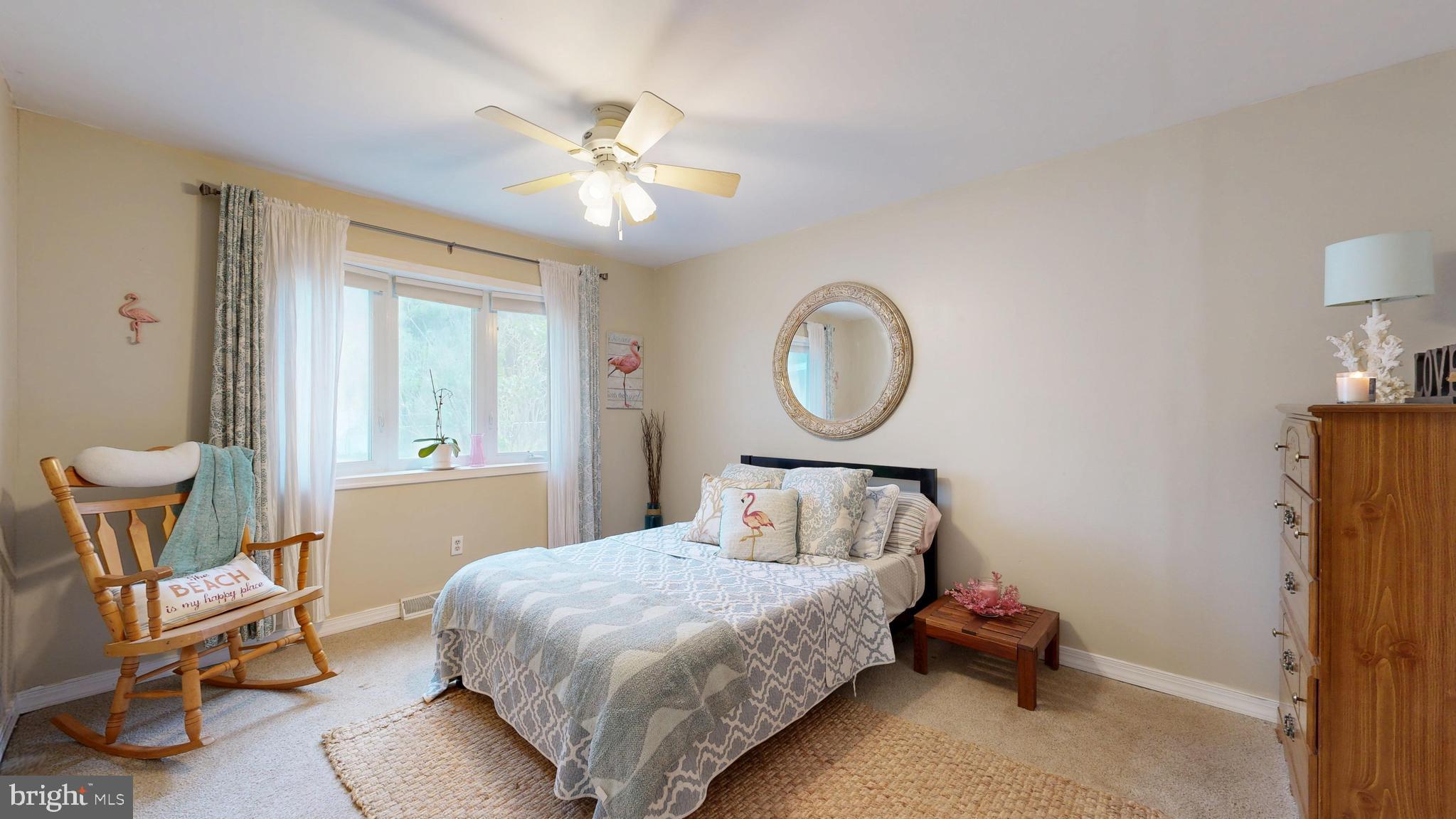 705 Deer Track Lane Dover, DE 19904 - Photo 19 of 29 a bedroom with a bed a chair and a window