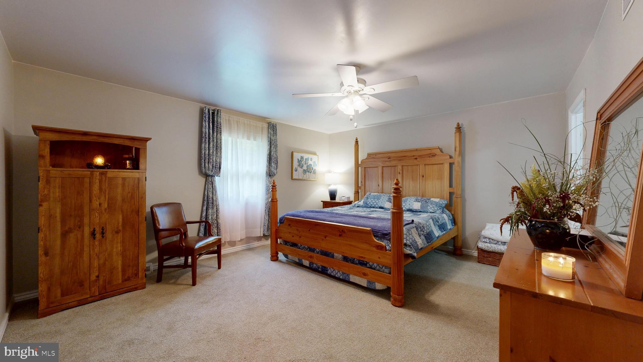 705 Deer Track Lane Dover, DE 19904 - Photo 24 of 29 a bedroom with a bed and a chandelier
