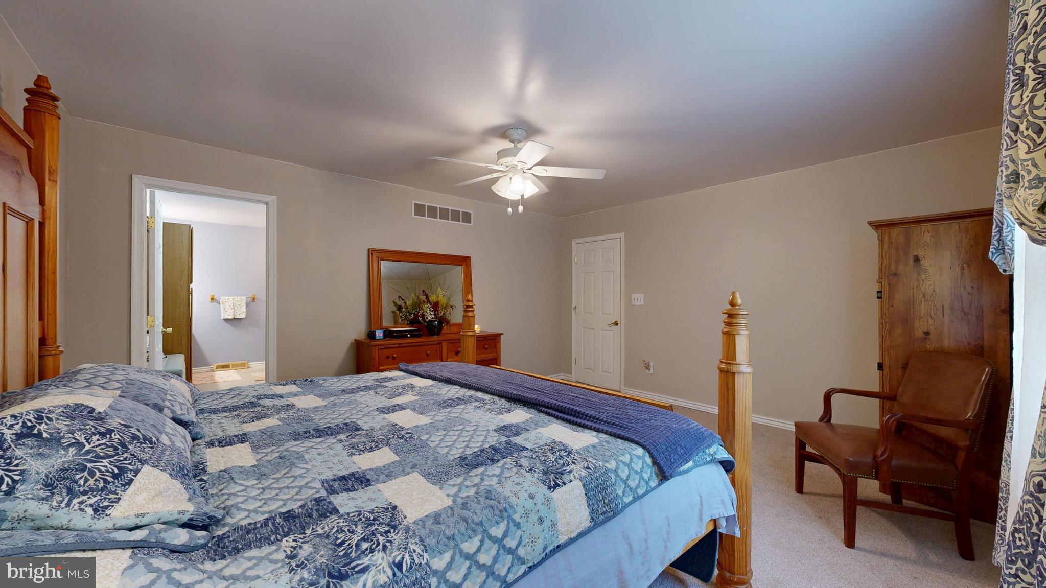 705 Deer Track Lane Dover, DE 19904 - Photo 25 of 29 a bedroom with a bed and a chandelier