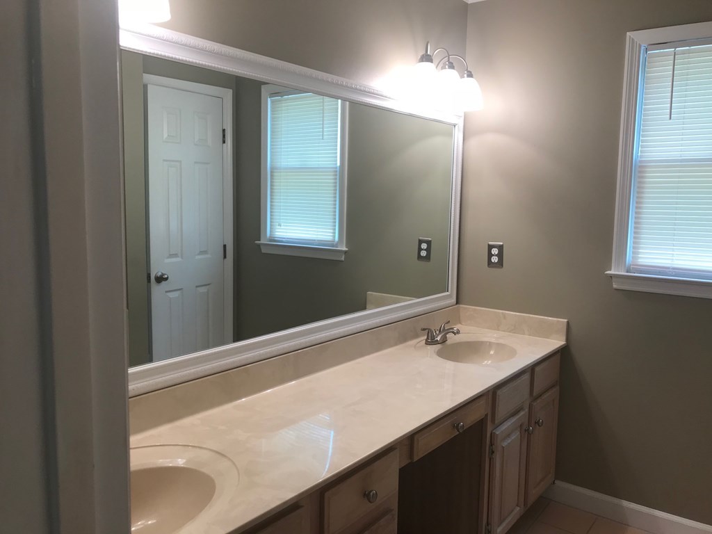 5931 Huddersfield Road Macon, GA 31210 - Photo 16 of 28 a bathroom with a sink and a mirror