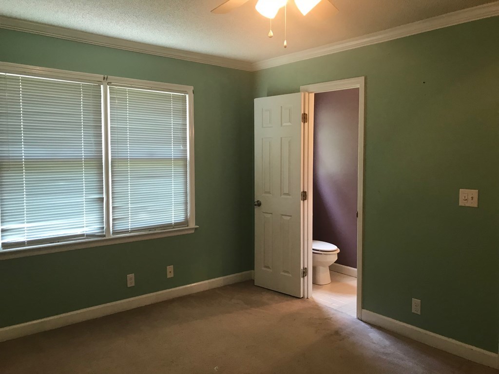 5931 Huddersfield Road Macon, GA 31210 - Photo 25 of 28 an empty room with a window and a bathroom
