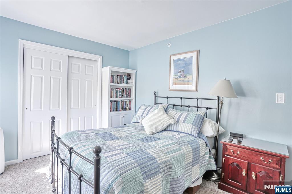 2009 Hawthorne Lane Mahwah, NJ 07430 - Photo 15 of 31 a bedroom with a bed and a bookshelf