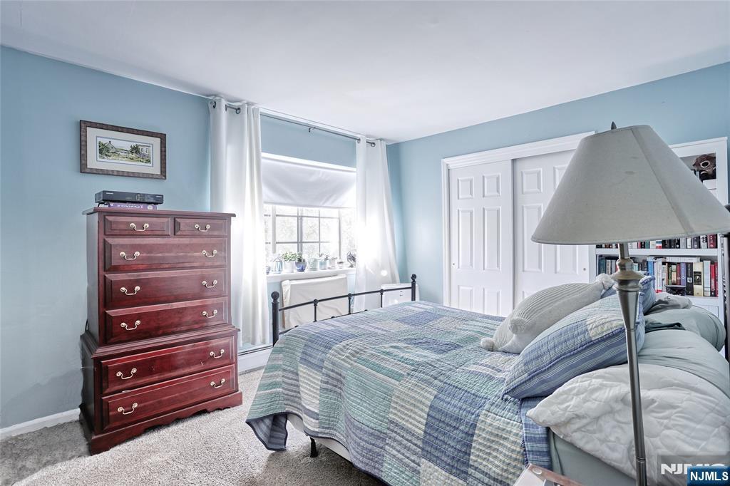 2009 Hawthorne Lane Mahwah, NJ 07430 - Photo 16 of 31 a bedroom with a bed and a lamp on dresser