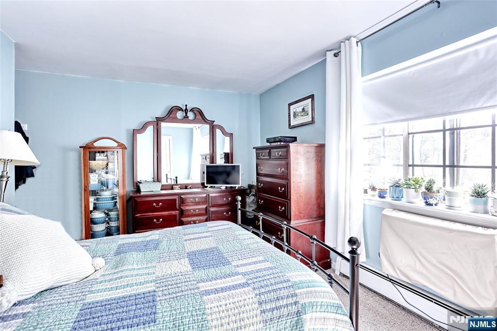 2009 Hawthorne Lane Mahwah, NJ 07430 - Photo 17 of 31 a bedroom with a bed and a large mirror on the dresser