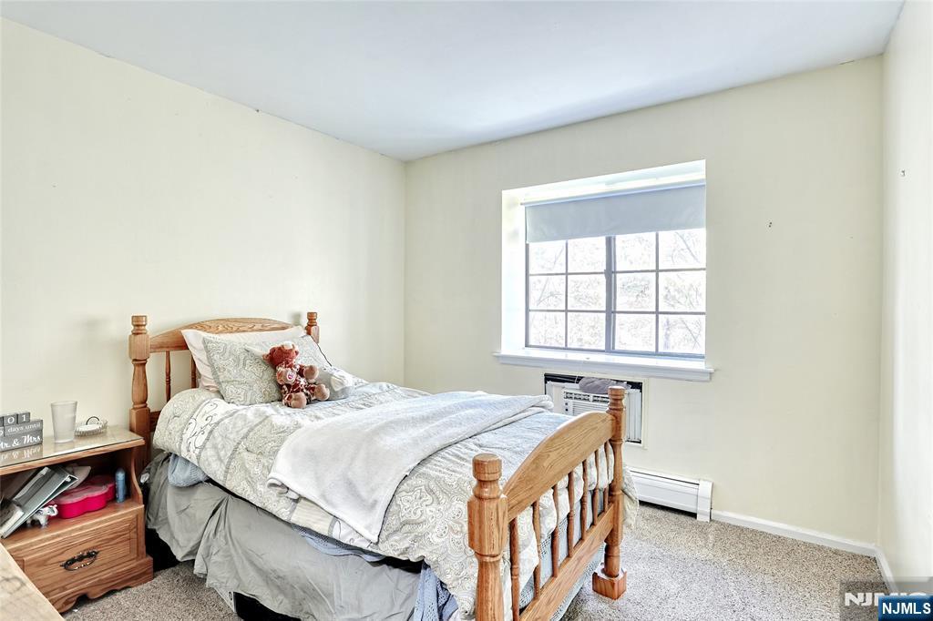2009 Hawthorne Lane Mahwah, NJ 07430 - Photo 18 of 31 a bed sitting in a bedroom next to a window