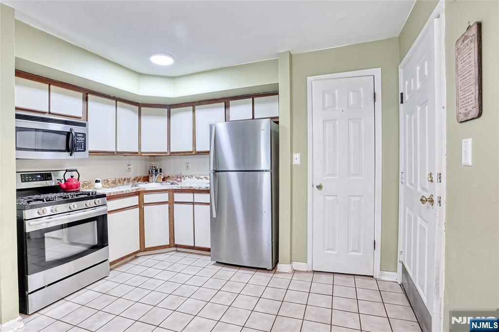2009 Hawthorne Lane Mahwah, NJ 07430 - Photo 9 of 31 a kitchen with stainless steel appliances granite countertop a refrigerator and a sink