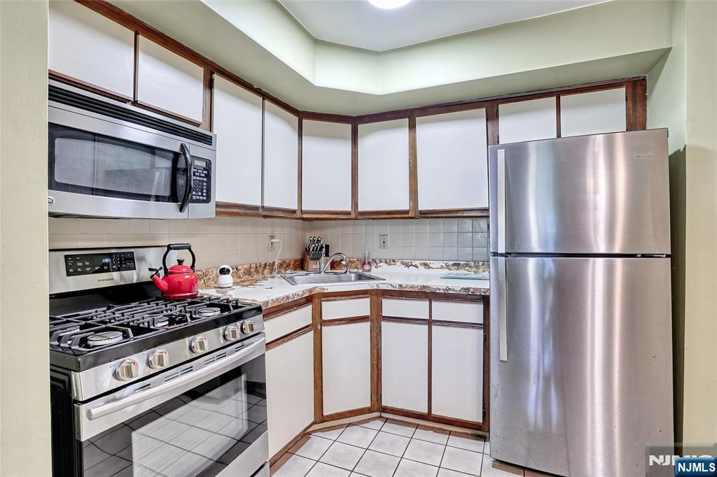 2009 Hawthorne Lane Mahwah, NJ 07430 - Photo 10 of 31 a kitchen with stainless steel appliances granite countertop a refrigerator sink stove and cabinets