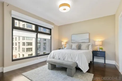 a bedroom with a bed and a large window