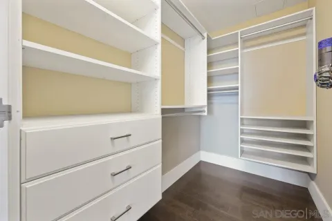 a view of walk in closet with empty racks