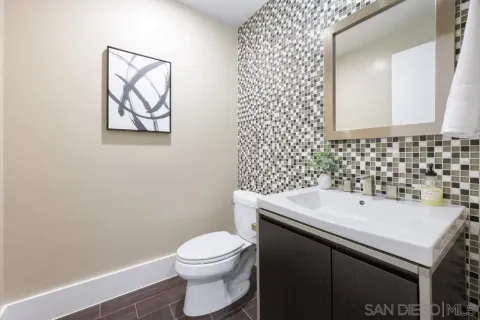 a bathroom with a sink a toilet and mirror