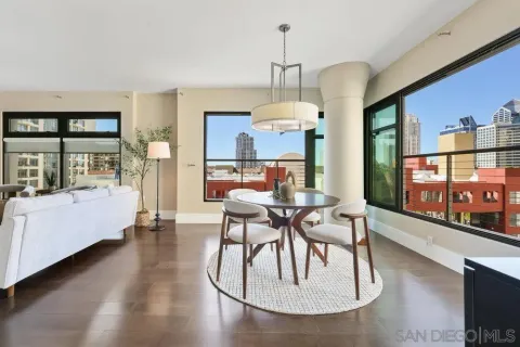 a view of a dining room with furniture a chandelier and wooden floor