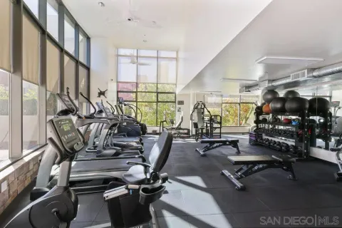 a view of a building with potted plants and a bench