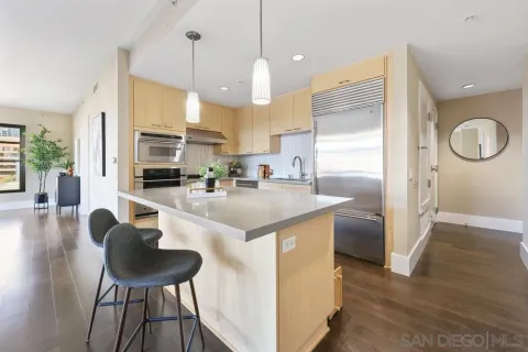 a kitchen with stainless steel appliances granite countertop a sink a stove and a refrigerator