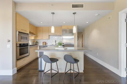 a kitchen with stainless steel appliances kitchen island a refrigerator and a stove top oven
