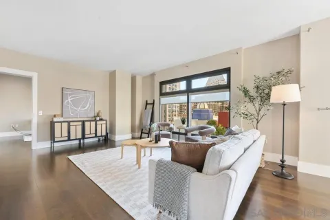 a living room with furniture and a large window