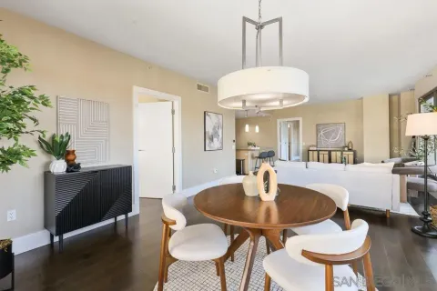 a view of a dining room with furniture and wooden floor