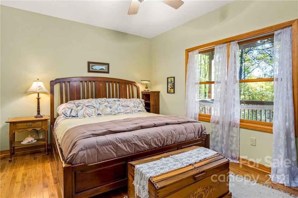 74 Apgar Road Candler, NC 28715 - Photo 12 of 46 a bedroom with a bed and wooden floor