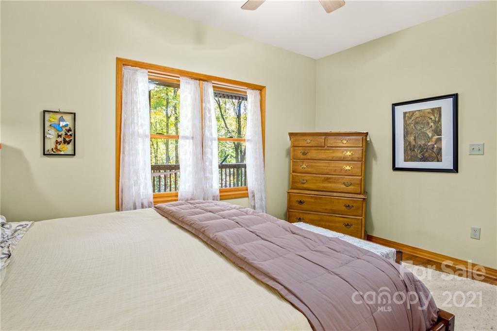 74 Apgar Road Candler, NC 28715 - Photo 13 of 46 a bedroom with a bed and a window